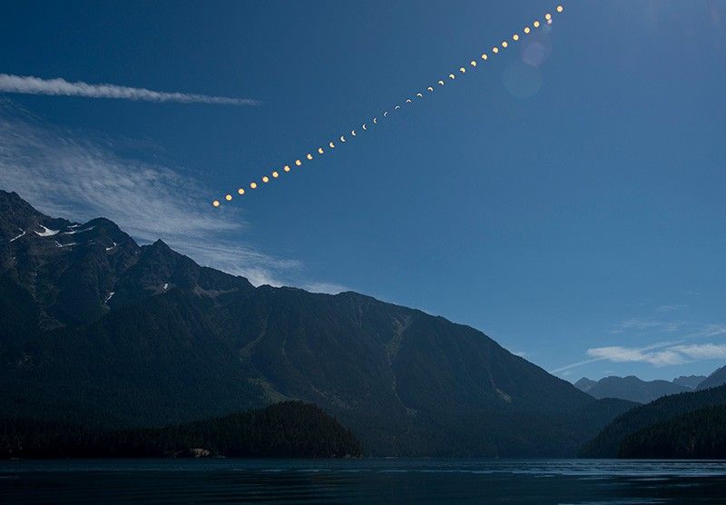 This composite image shows the progression of a partial solar eclipse over Ross Lake, in Northern Cascades National Park, Washington on Monday, Aug. 21, 2017.