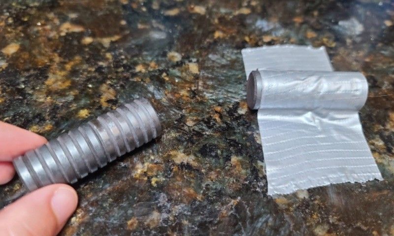 A person holds two stacks of magnets to feel their interaction