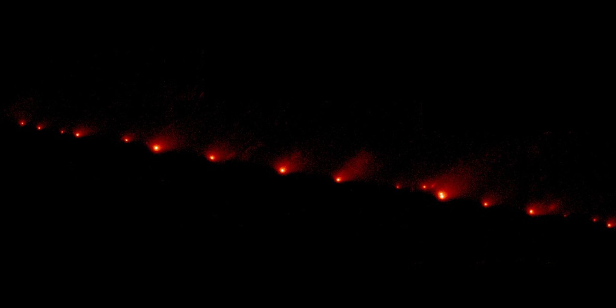 Fuzzy string of comet pieces in space.
