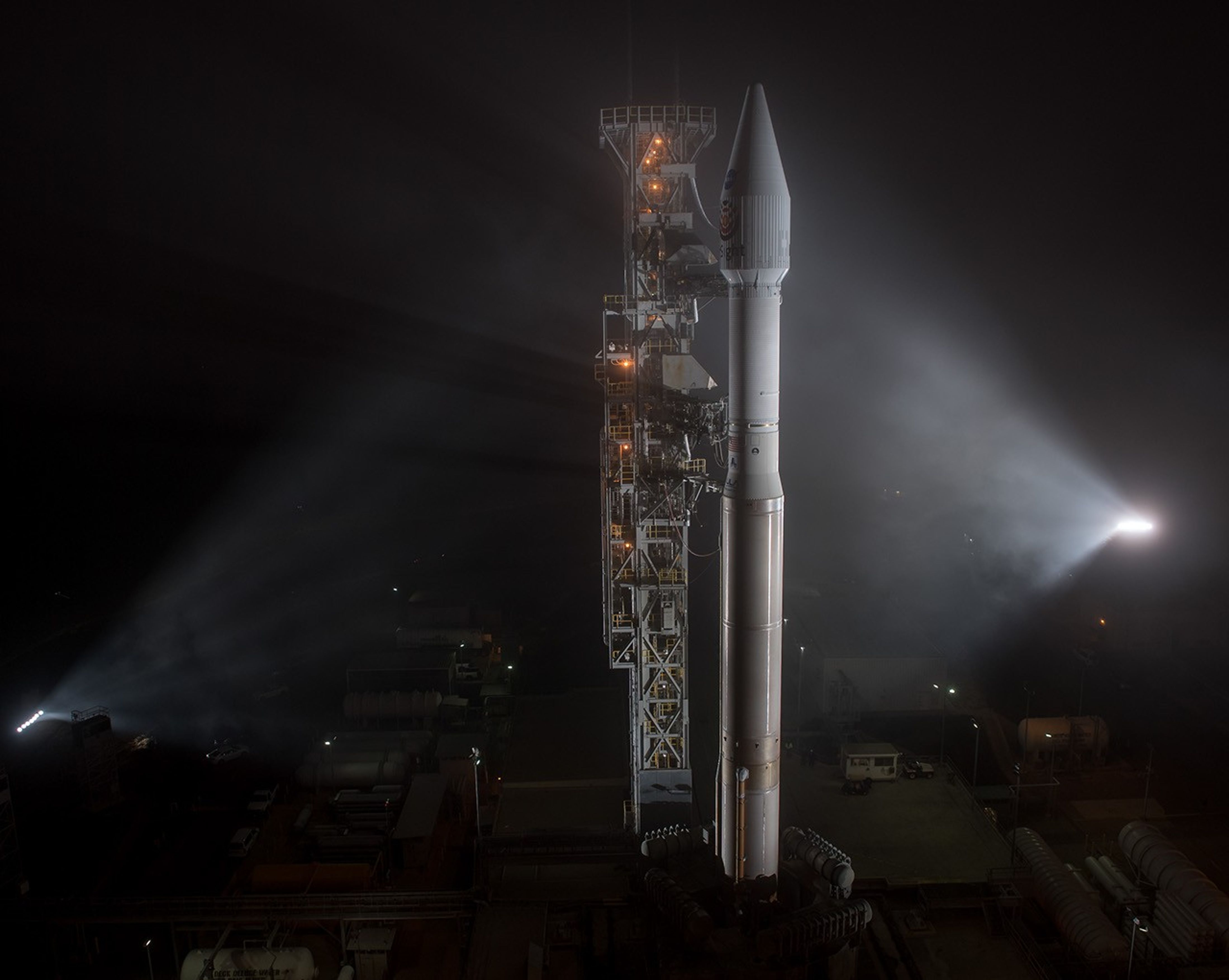 Spotlights on rocket on the launchpad.