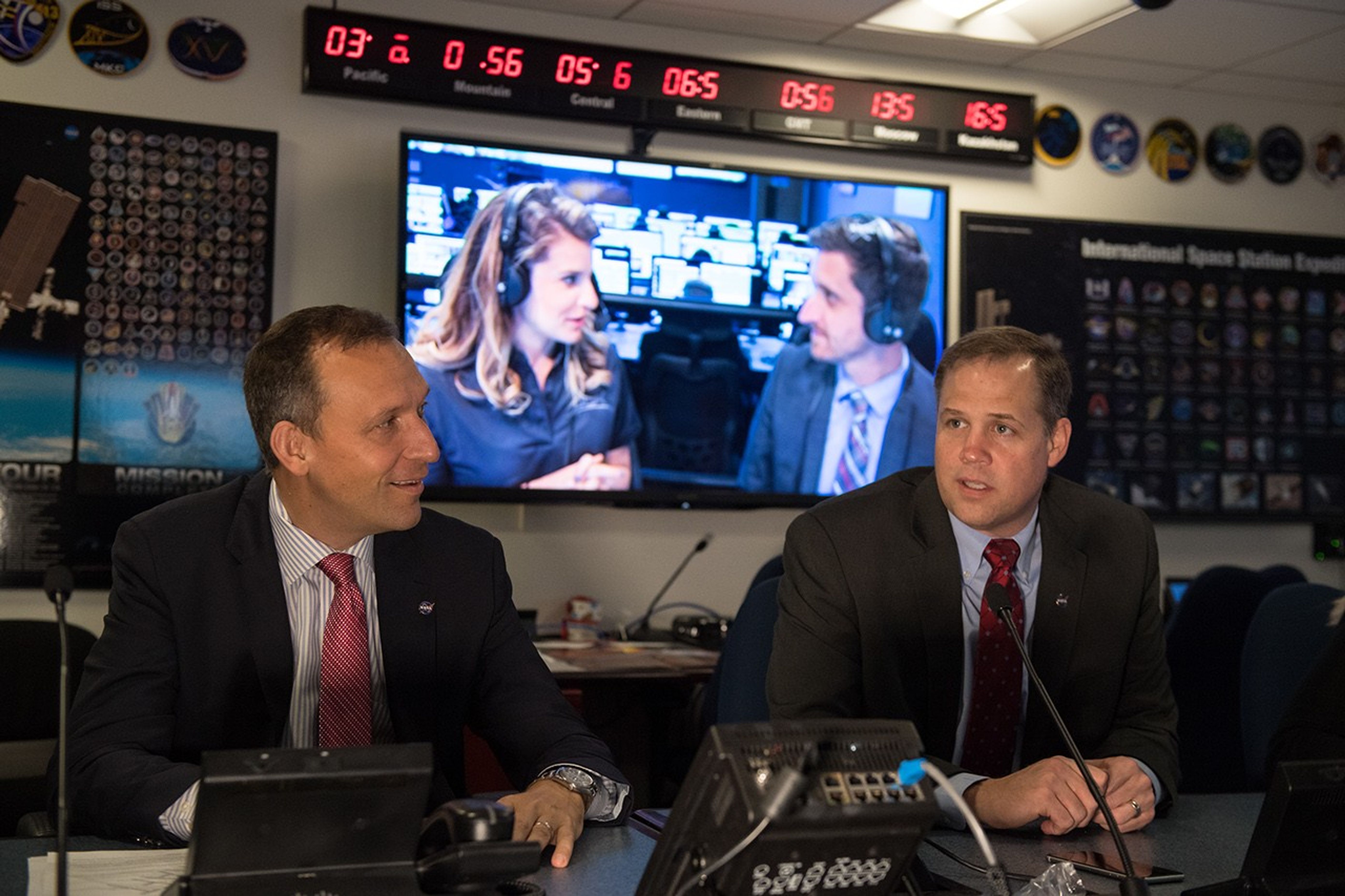 Two men in control room.