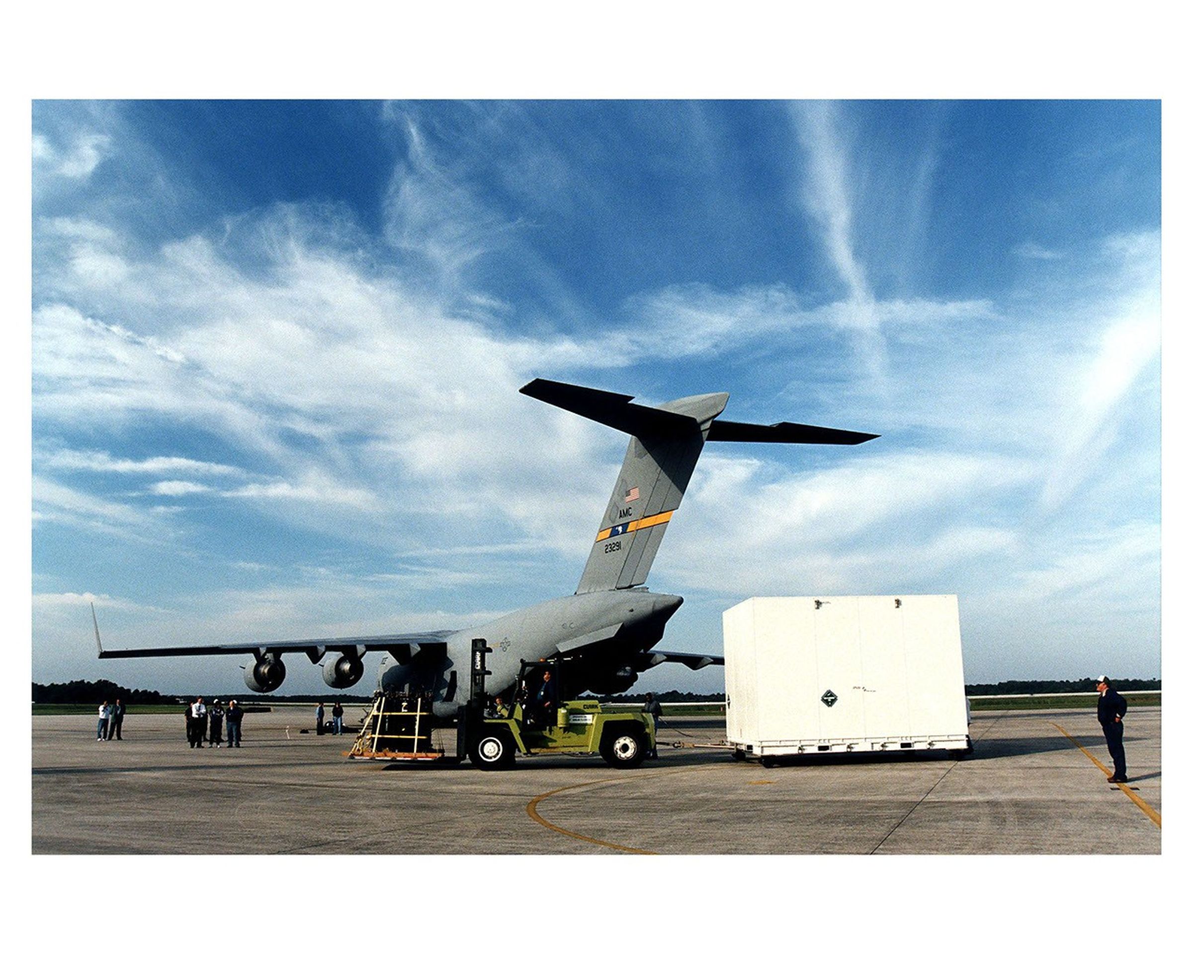 Giant crate being removed from giant airplane.