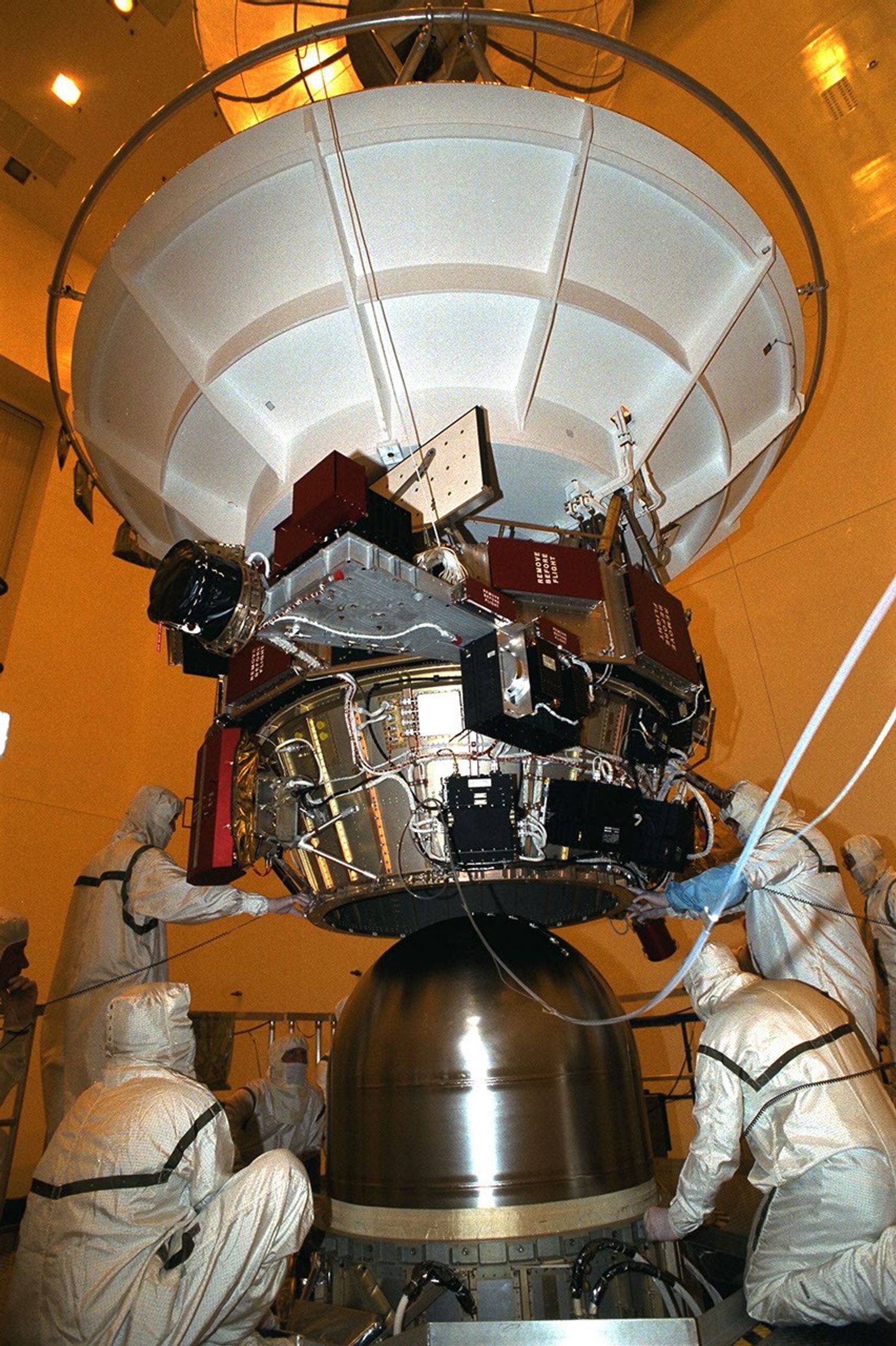 Technicians working on spacecraft fuel tank.