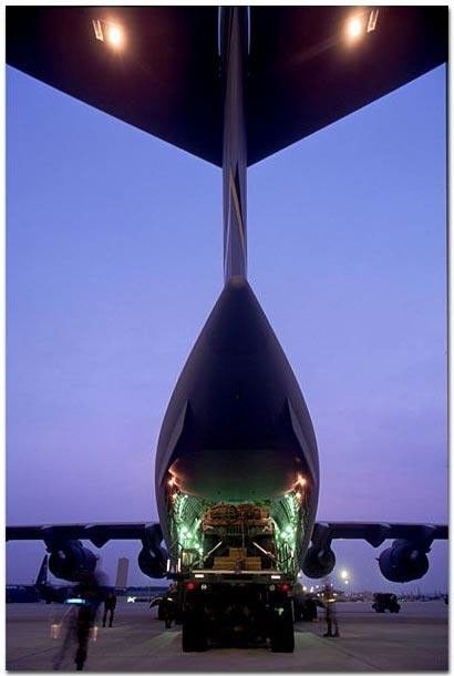 Large spacecraft container on inside a giant military plane.