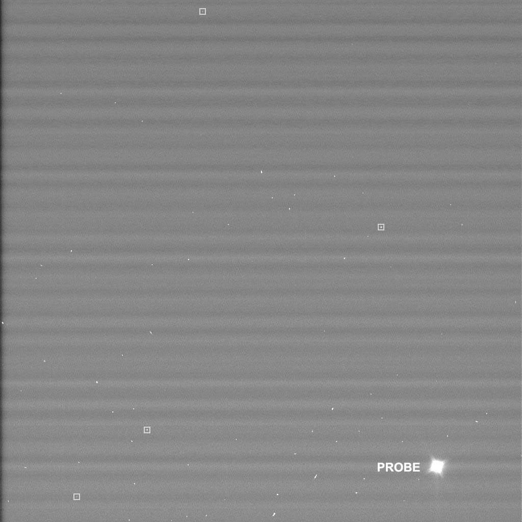 Black and white image with labeles showing the location of the Huygens Probe two days after its release on a course to Titan. The probe appears as a bright white spot.