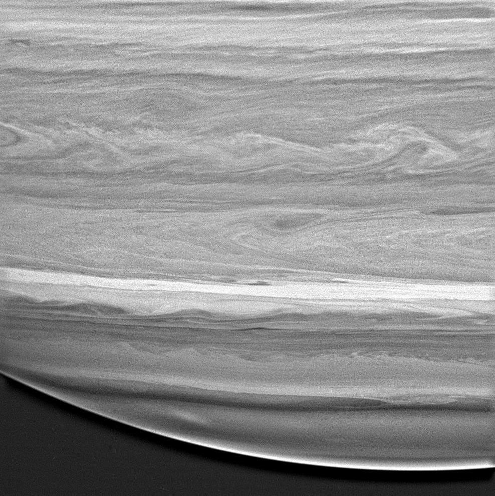 black and white image of saturn showing cloud swirls and details
