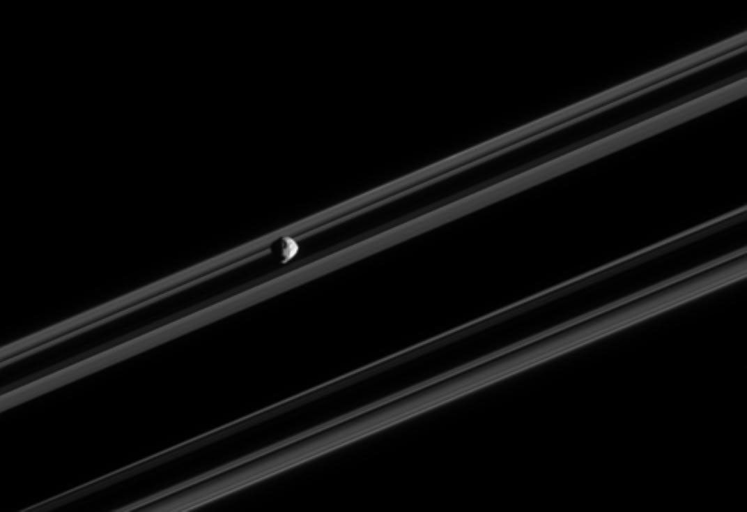 Saturn's moon Epimetheus near a portion of the rings
