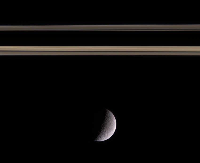 Rhea near a part of Saturn's rings