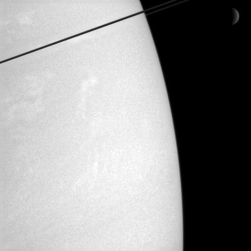 Clouds on Saturn and Rhea in the distance