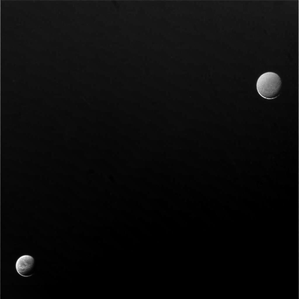 Dione (lower left) and Rhea (upper right)