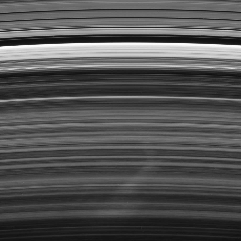 A bright spoke extends across the unilluminated side of Saturn's B ring