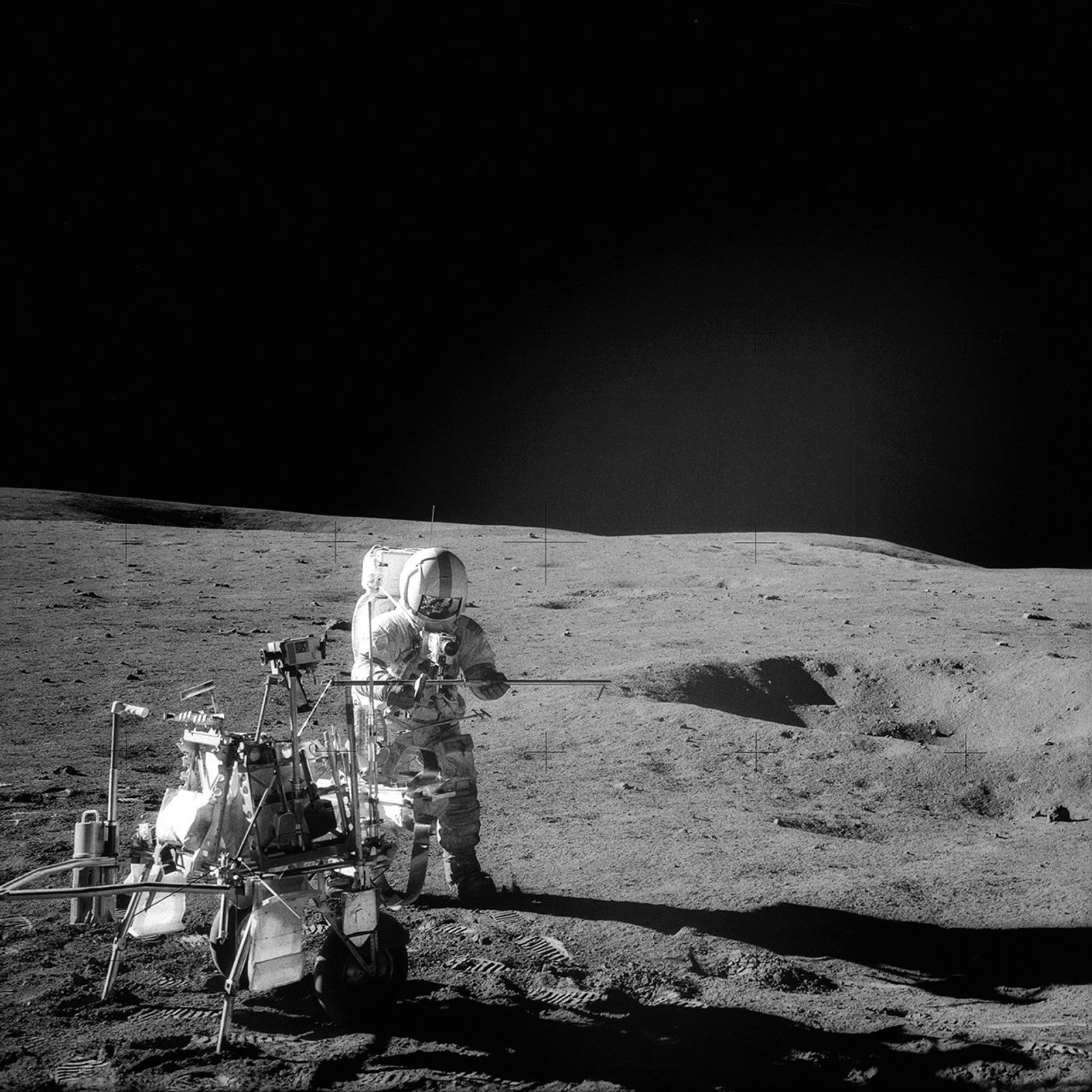 Astronaut assembling a tube on the Moon.