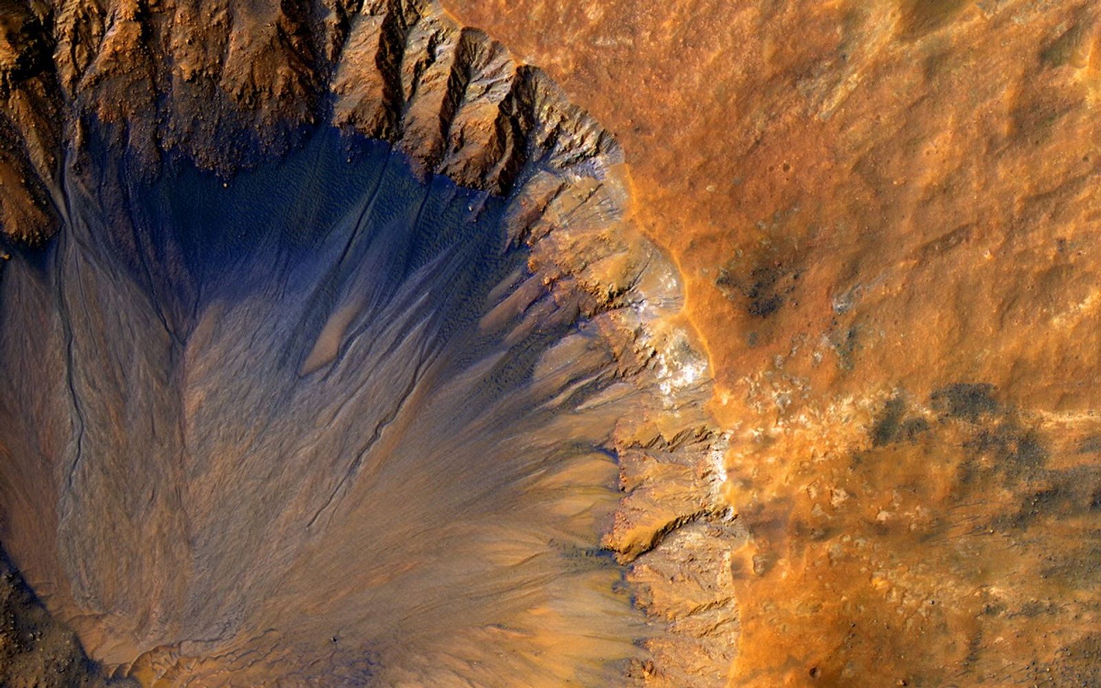 This impact crater appears relatively recent as it has a sharp rim and well-preserved ejecta, the material thrown out of the crater when a meteorite hit Mars.