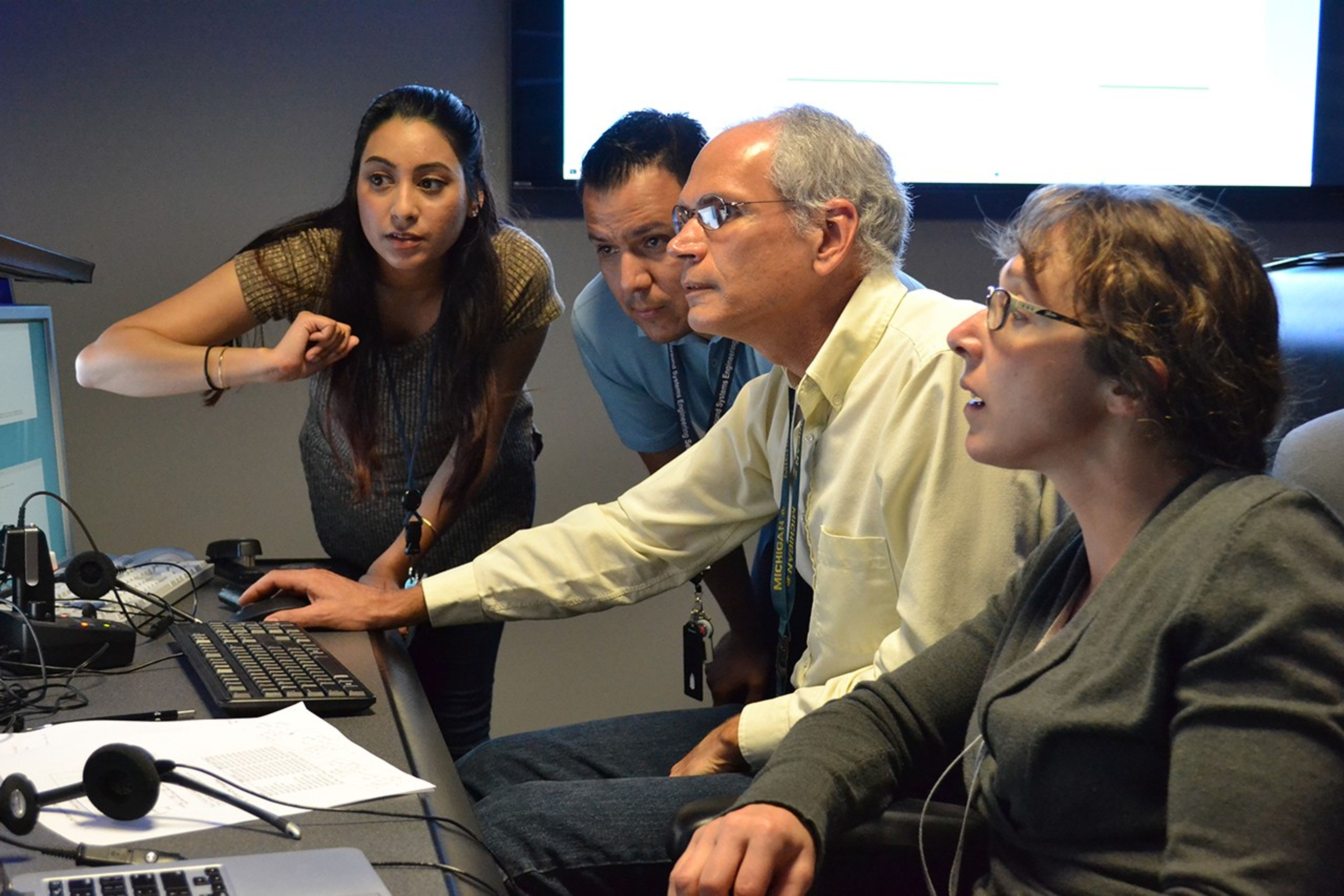 Color image of people at a computer console.