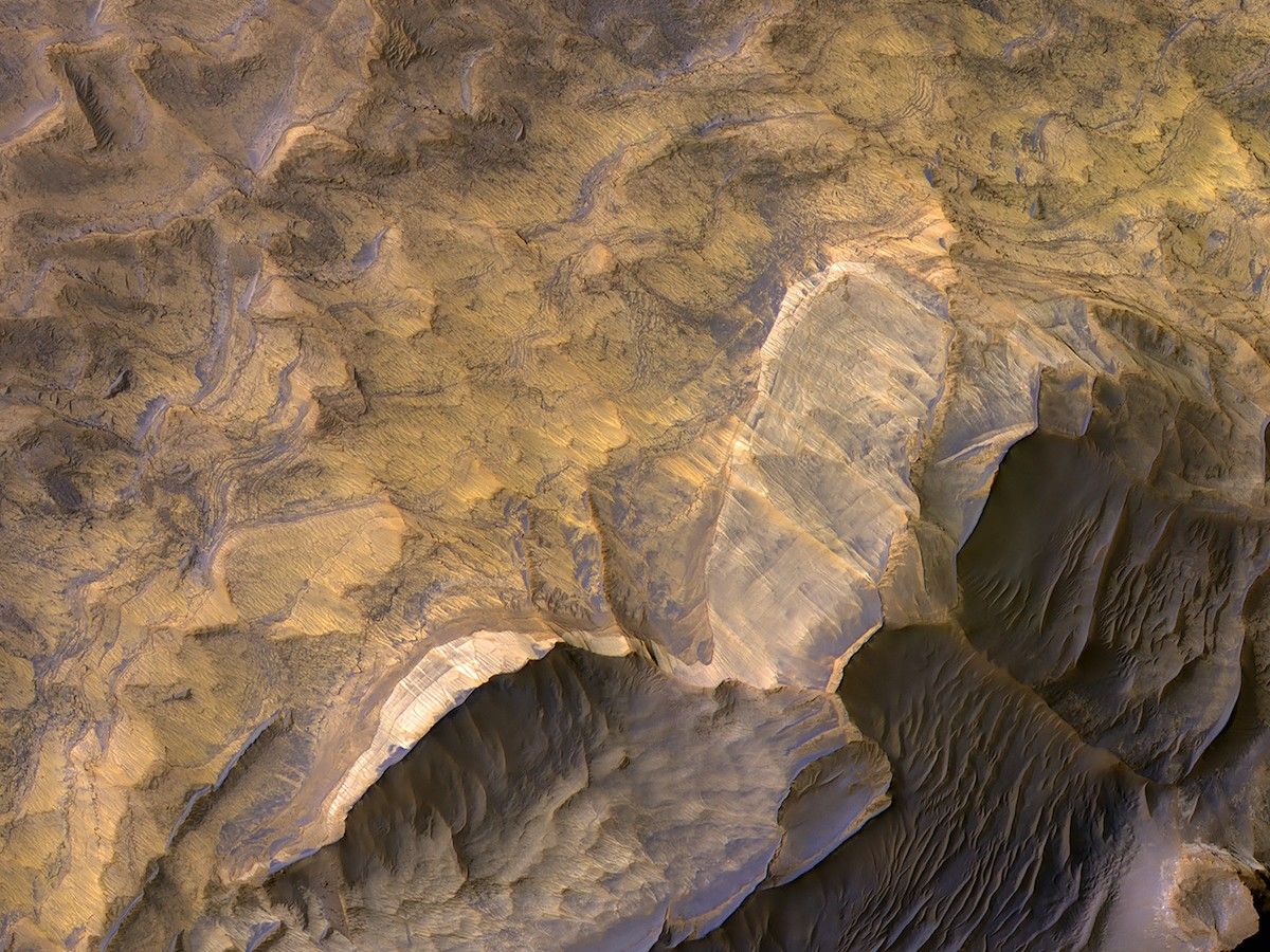 desert landscape with rock outcroppings and dunes seen from above