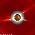 A golden circle, surrounded by a gray circle, surrounded by a red circle. This is a coronograph, revealing the Sun's atmosphere.
