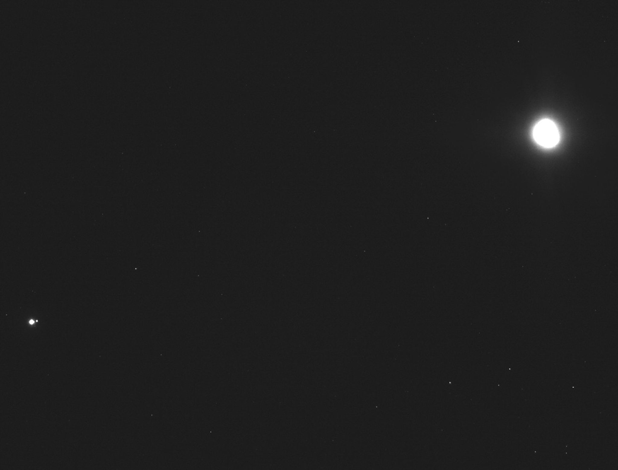 Earth, Moon and Bennu as bright spots against the blackness of space.