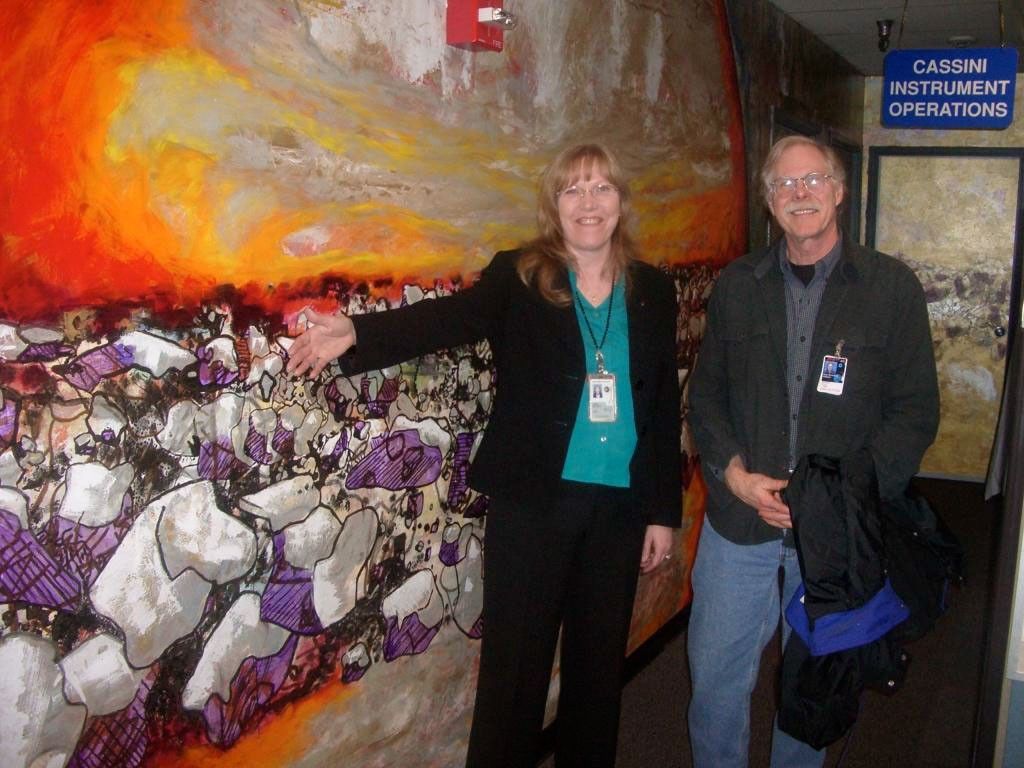 Linda Spilker, Cassini deputy project scientist, and Jeff Cuzzi, Saturn ring specialist, stand in front of a section of the mural
