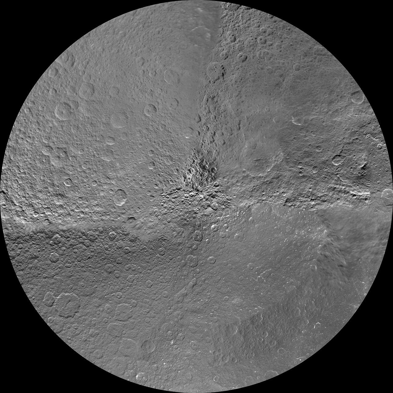 The northern and southern hemispheres of Rhea are seen in these polar stereographic maps, mosaicked from the best-available Cassini and Voyager images.