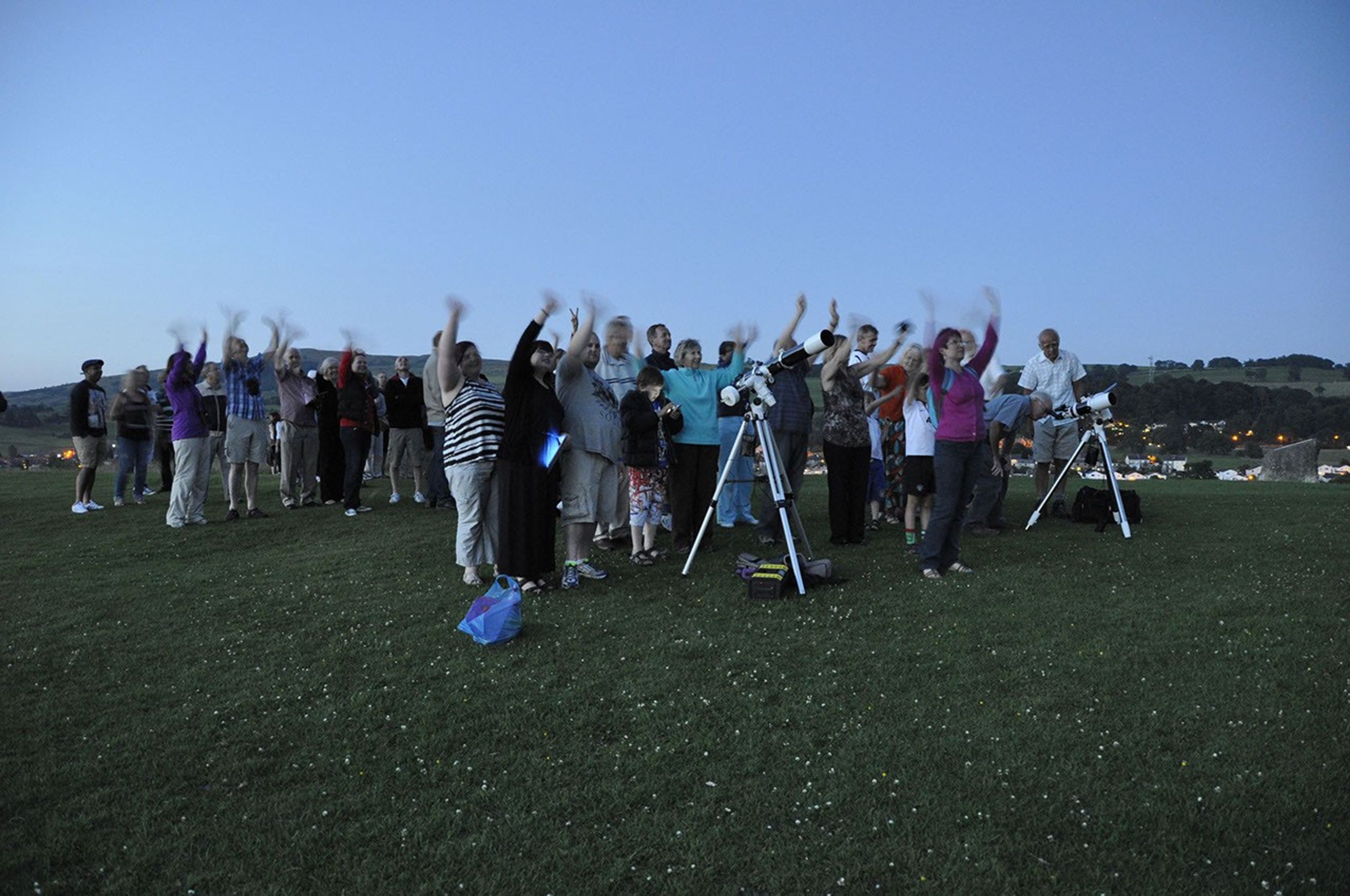 Telescopes, telephone and tablets at the ready, a group of amateur astronomers gathers under twilight skies to wave at Saturn on July 19, 2013. Their gathering in the town of Kendal in England's Cumbria district was one of many international celebrations as Earth was imaged from deep space by NASA's Cassini spacecraft.