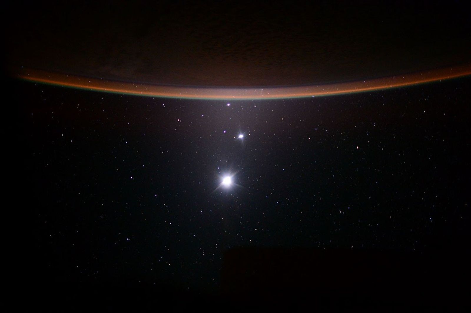 Crescent Earth above a lineup of Jupiter, Venus and Earth's Moon.