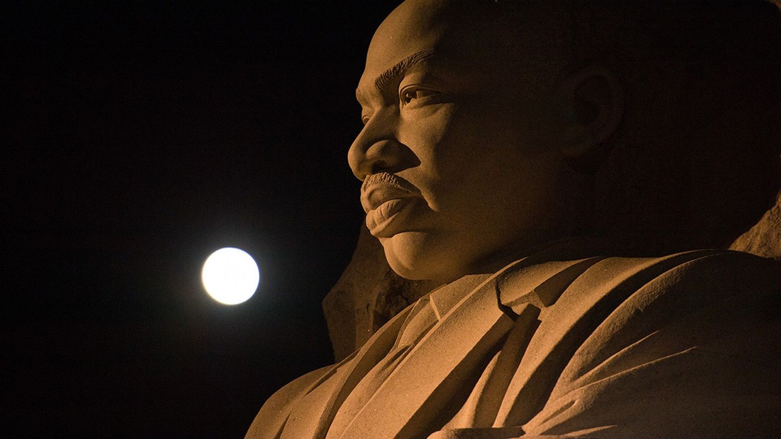Full Moon over giant statue of the Martin Luther King Jr.