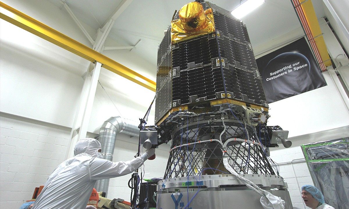 NASA's Lunar Atmosphere and Dust Environment Explorer (LADEE) Observatory is mounted on the vibration table prior to the start of testing, and technicians are removing the protective covers from the delicate thrusters in preparation to begin vibration testing.