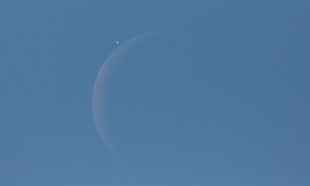 Venus is seen next to the crescent moon during the daytime, prior to the start of occultation, on Monday, 7 December 2015 in Washington, D.C.