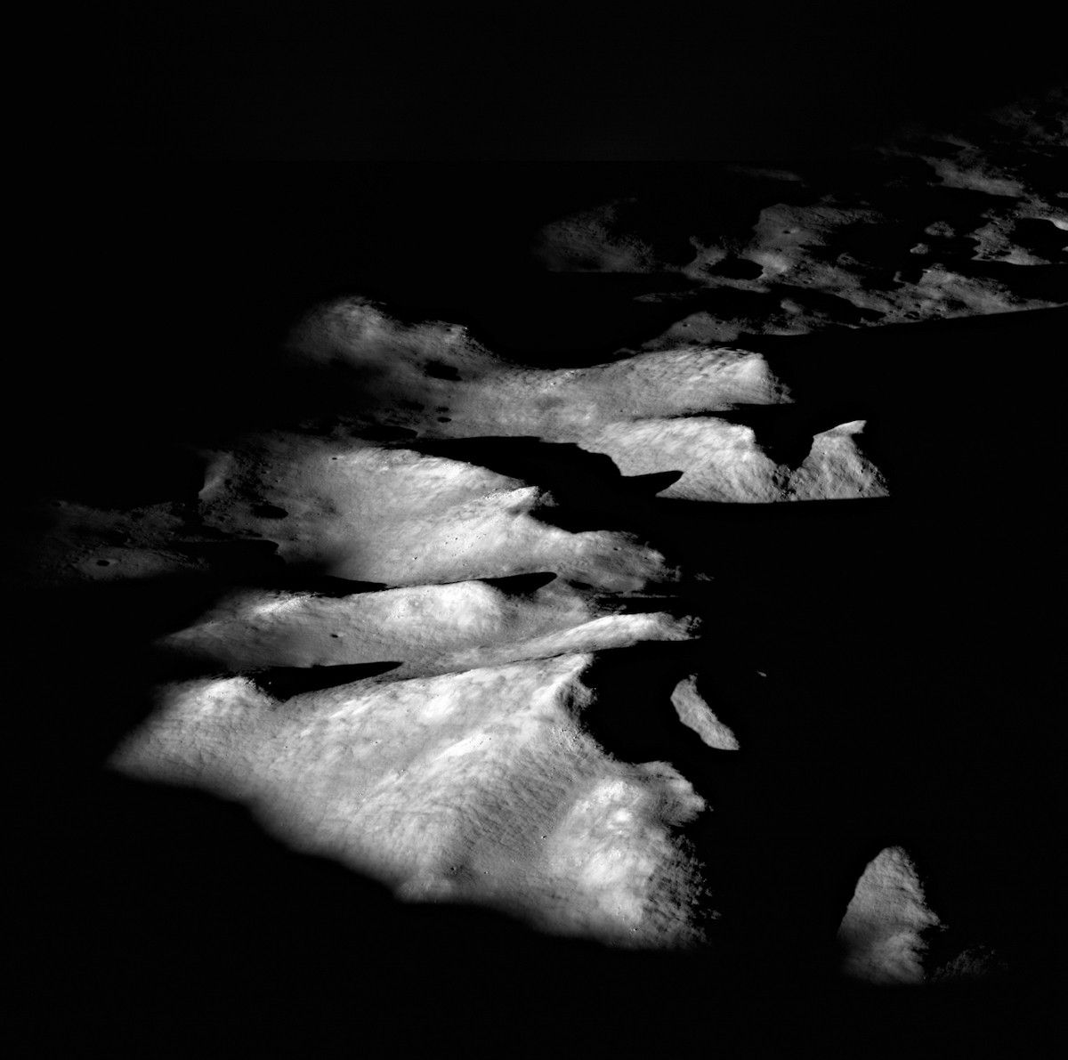 gray hills rising above a shadowed plain