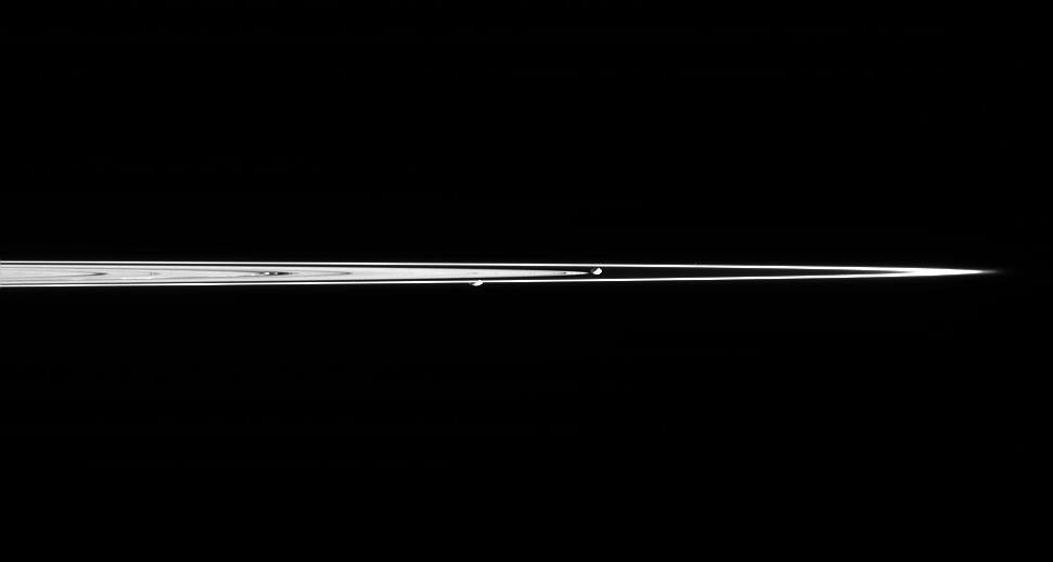 Prometheus and Pandora are captured here in a single image taken from less than a degree above the dark side of Saturn's rings.