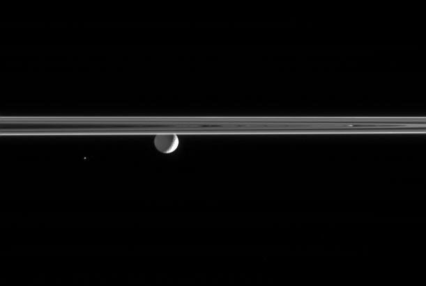Saturn's moons Mimas and Helene near a portion of the rings