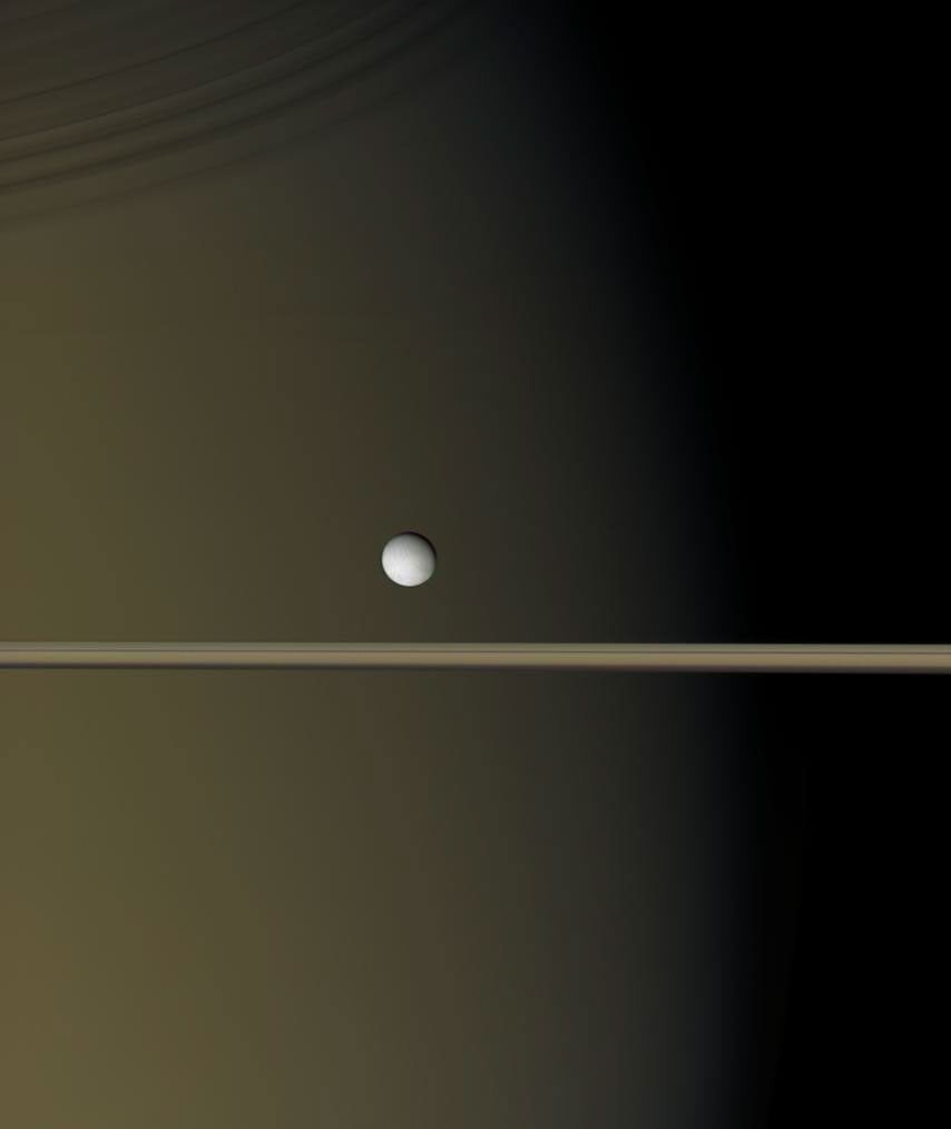 Enceladus by Saturn and the rings