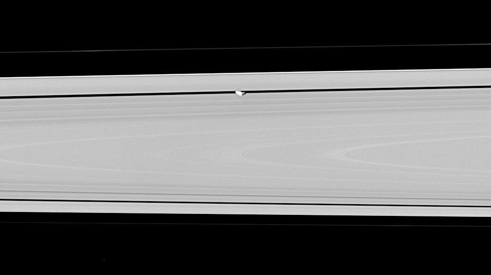 Saturn's moon Pan, partly in shadow and party cut off by the outer A ring