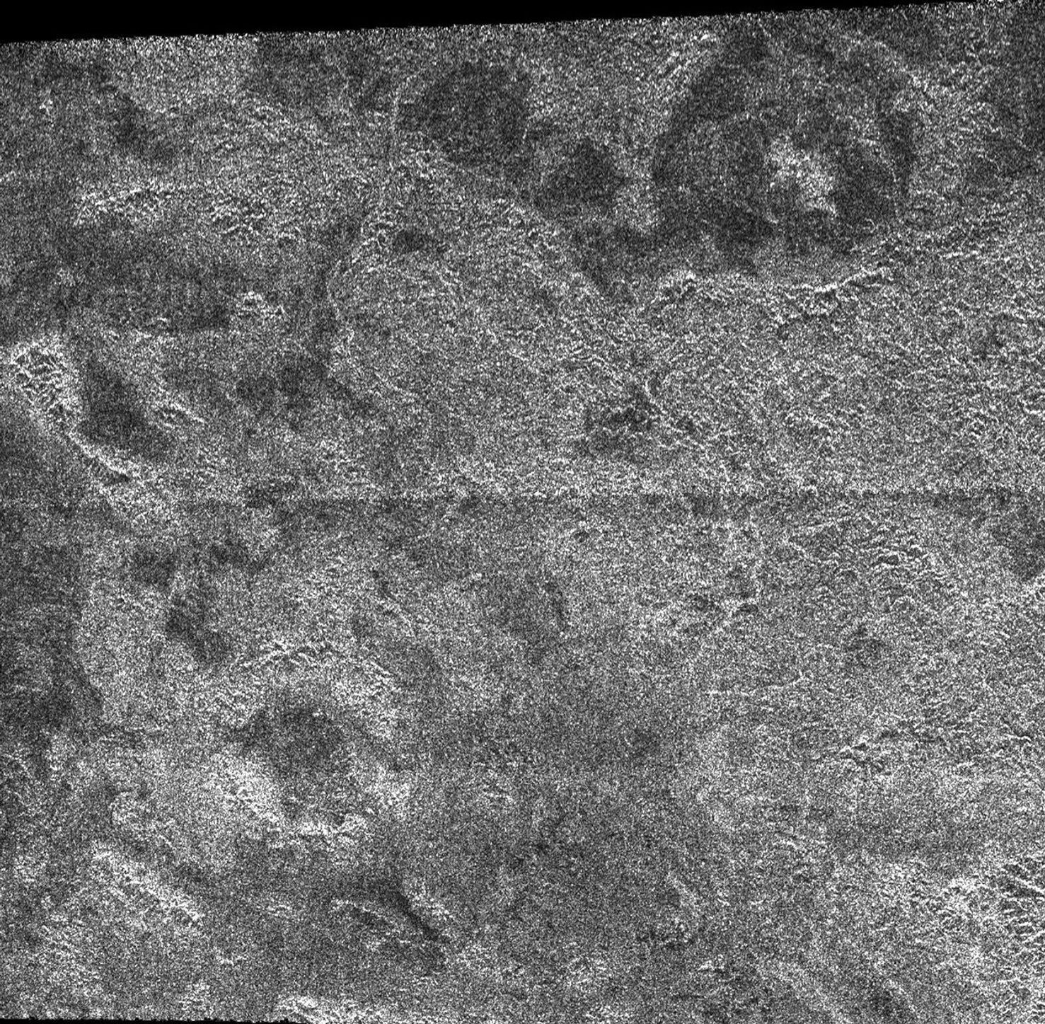This image shows the radar-bright region Xanadu and two circular features interpreted to be degraded impact craters