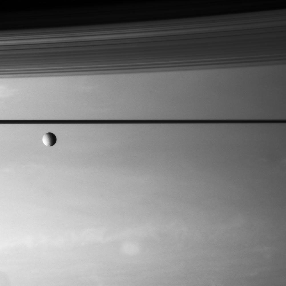 Tethys in front of Saturn