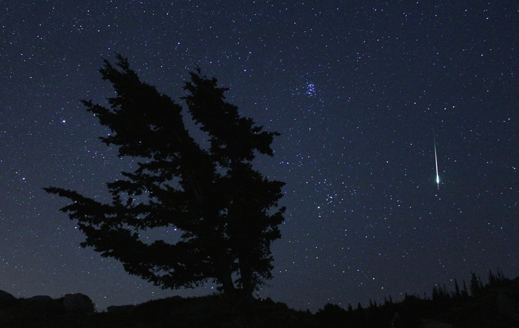 In this 20-second exposure, a meteor lights up the sky over the top of a mountain ridge near Park City, Utah.