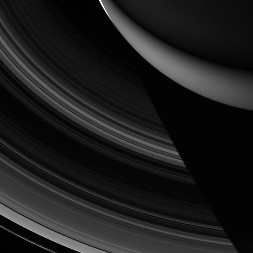 Saturn's rings disappearing into the planet's shadow