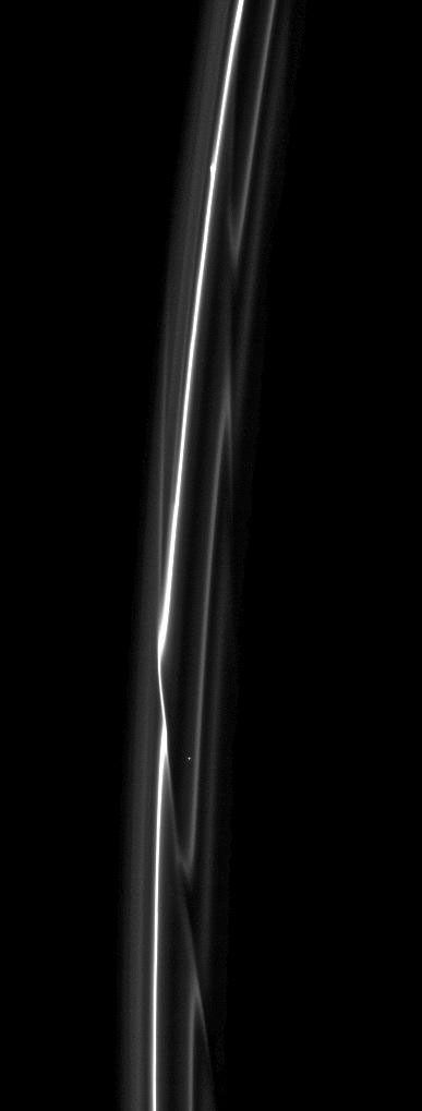 Set starkly against the blackness of space are the F ring's delicate strands which are periodically gored by its shepherding moon, Prometheus.