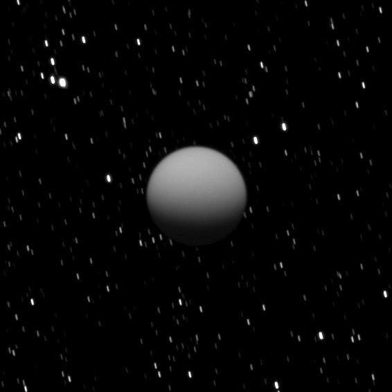 The Cassini spacecraft captured this image of a dimly lit Titan as Saturn's largest moon was eclipsed by the planet.