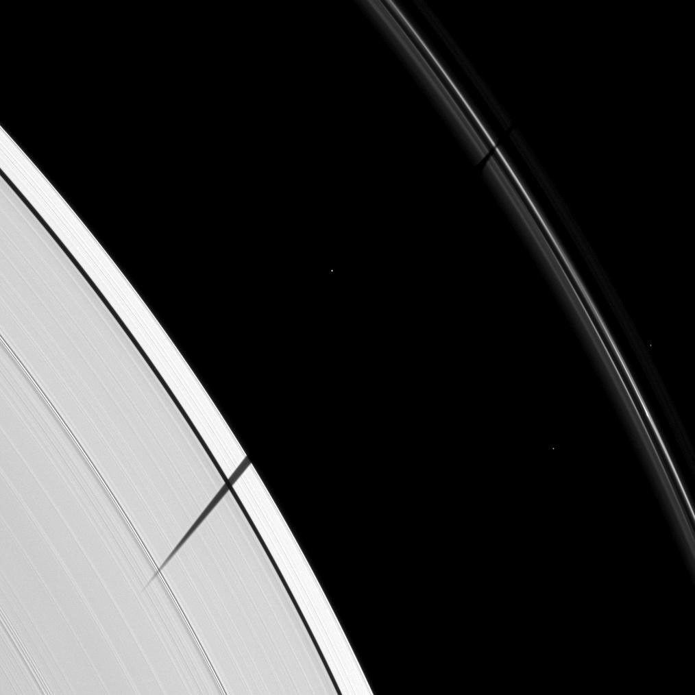 The Cassini spacecraft catches Janus joining other Saturnian moons in the equinox shadow-casting party.