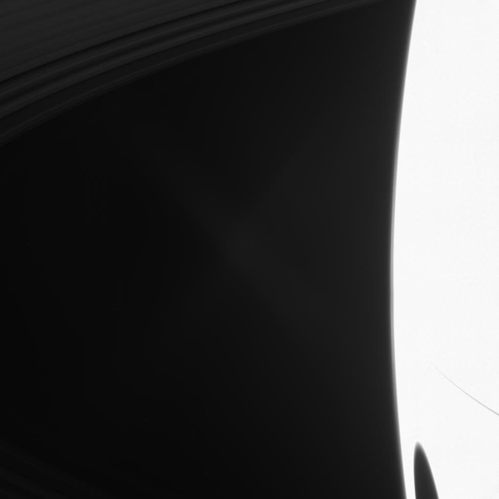 Titan's shadow darkens Saturn