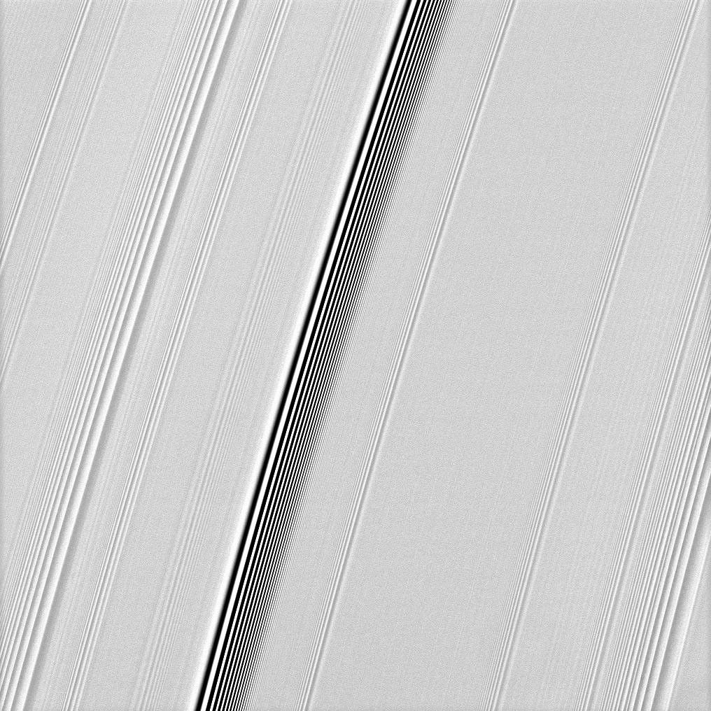 The Cassini spacecraft spies two types of waves in Saturn's A ring: a spiral density wave on the left of the image and a more pronounced spiral bending wave near the middle.