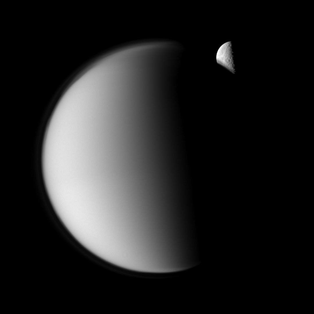 Rhea moves behind Titan