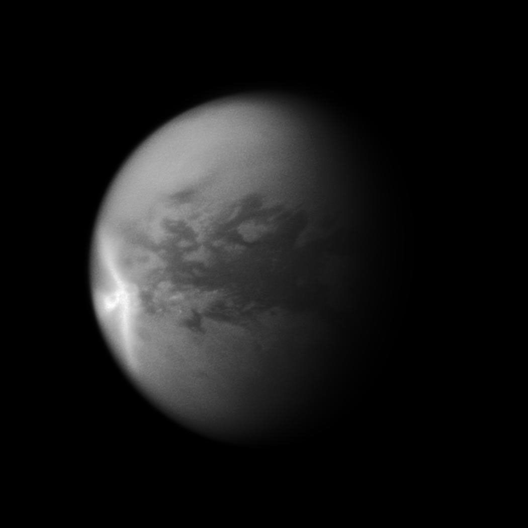 A huge arrow-shaped storm blows across the equatorial region of Titan in this image from NASA's Cassini spacecraft, chronicling the seasonal weather changes on Saturn's largest moon.