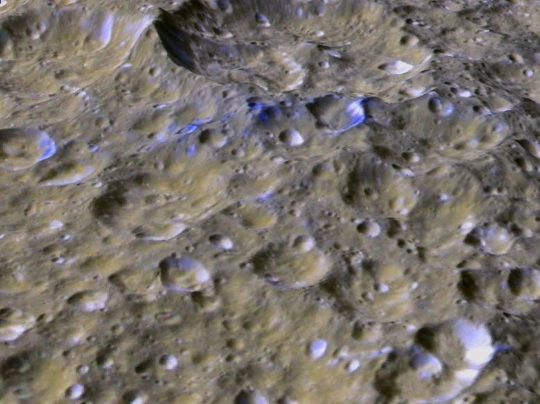 This perspective view shows one of a series of relatively blue patches that form a very narrow band only 10 kilometers wide that straddles Rhea's equator.