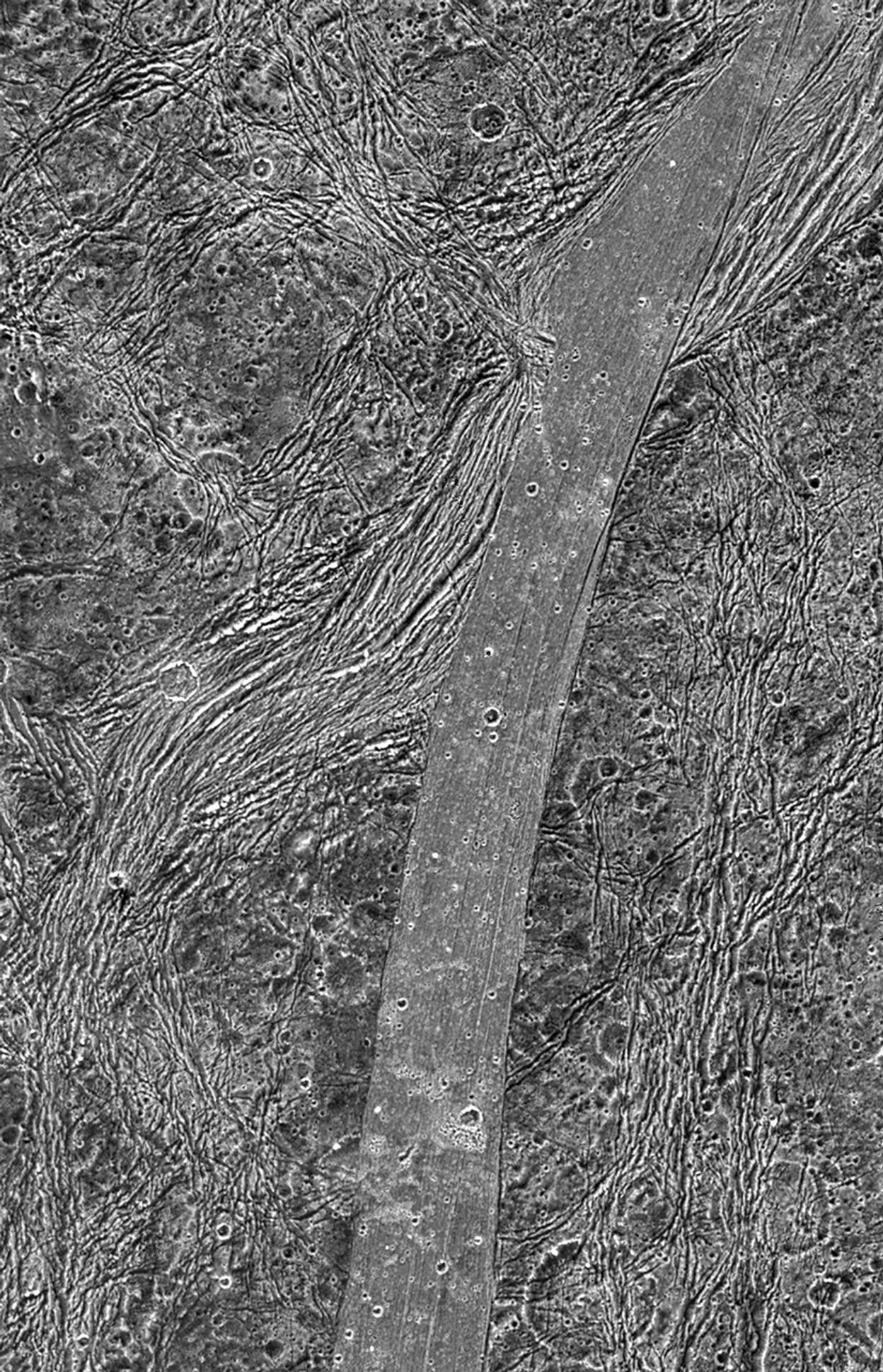 Close orbital view showing rugged moon terrain.