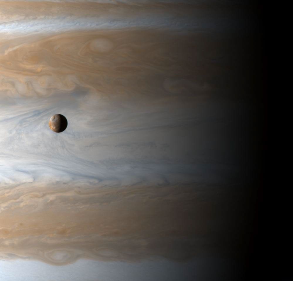 The Galilean satellite Io floats above the cloudtops of Jupiter in this image captured on the dawn of the new millennium, January 1, 2001 10:00 UTC (spacecraft time), two days after Cassini's closest approach.