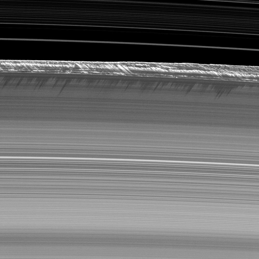 Vertical structures, among the tallest seen in Saturn's main rings, rise abruptly from the edge of Saturn's B ring to cast long shadows on the ring in this image taken by NASA's Cassini spacecraft two weeks before the planet's August 2009 equinox.