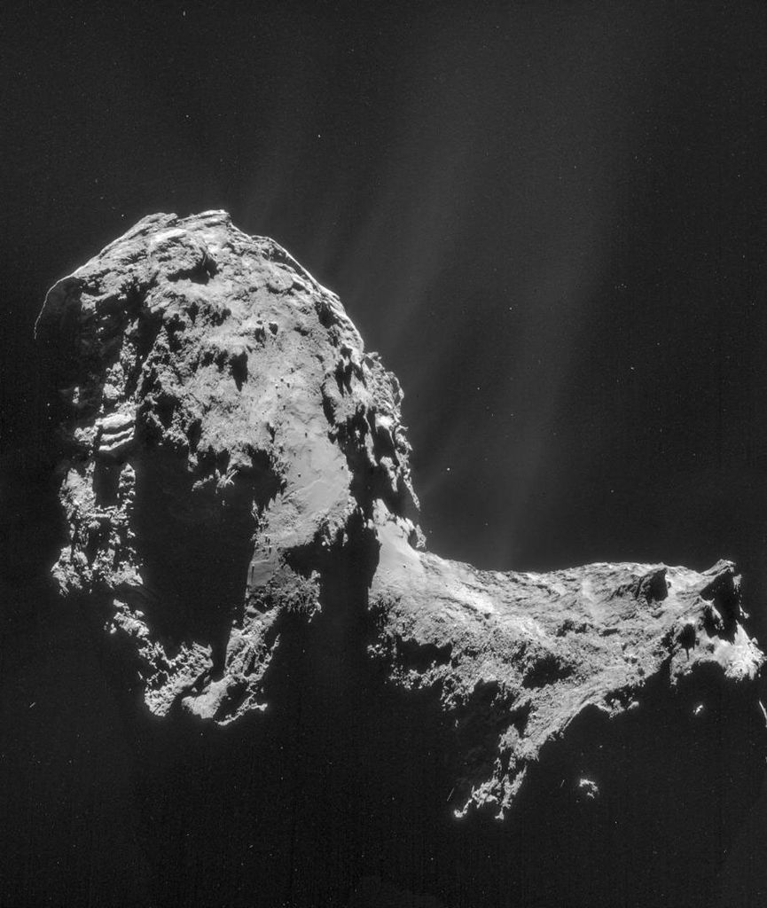 A peanut-shaped comet is shown with jets of material being ejected from its surface.
