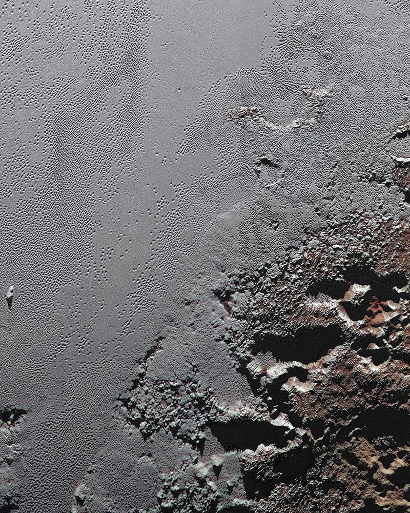 This enhanced color view from NASA's New Horizons spacecraft zooms in on the southeastern portion of Pluto's great ice plains, where at lower right the plains border rugged, dark highlands informally named Krun Macula.